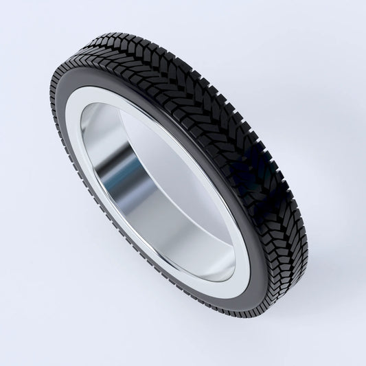 Sterling silver ring on a white background, this ring is shaped like a car's tyre, and shows the design in silver with the 3d printed tyre