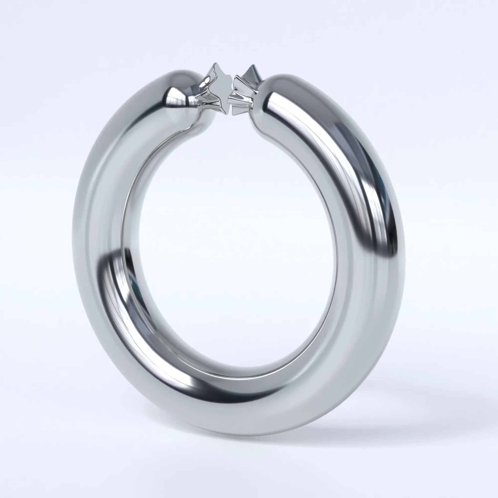 Sterling silver ring shaped like a sausage bent into a circle on a light grey background