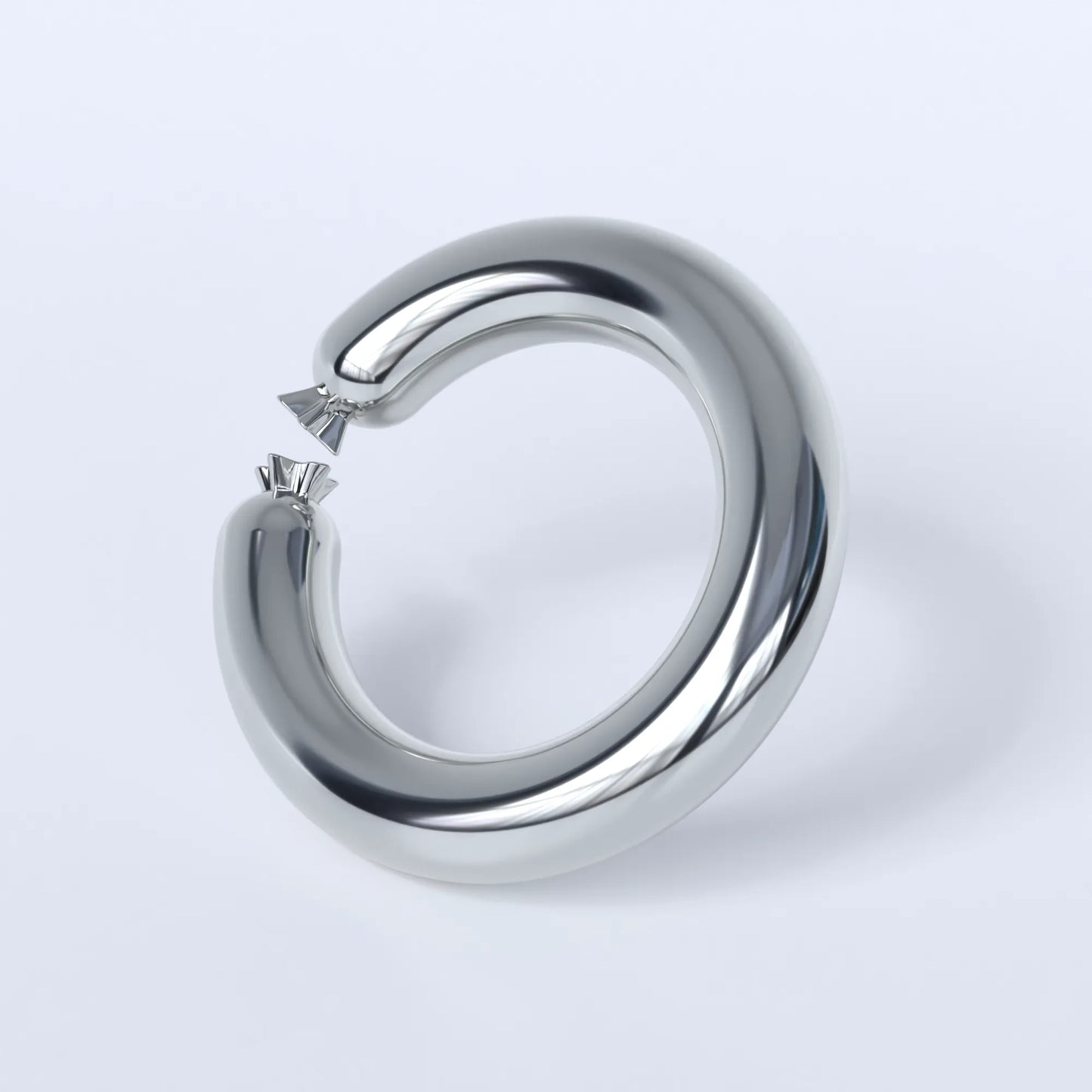 Sterling silver ring shaped like a sausage bent into a circle on a light grey background
