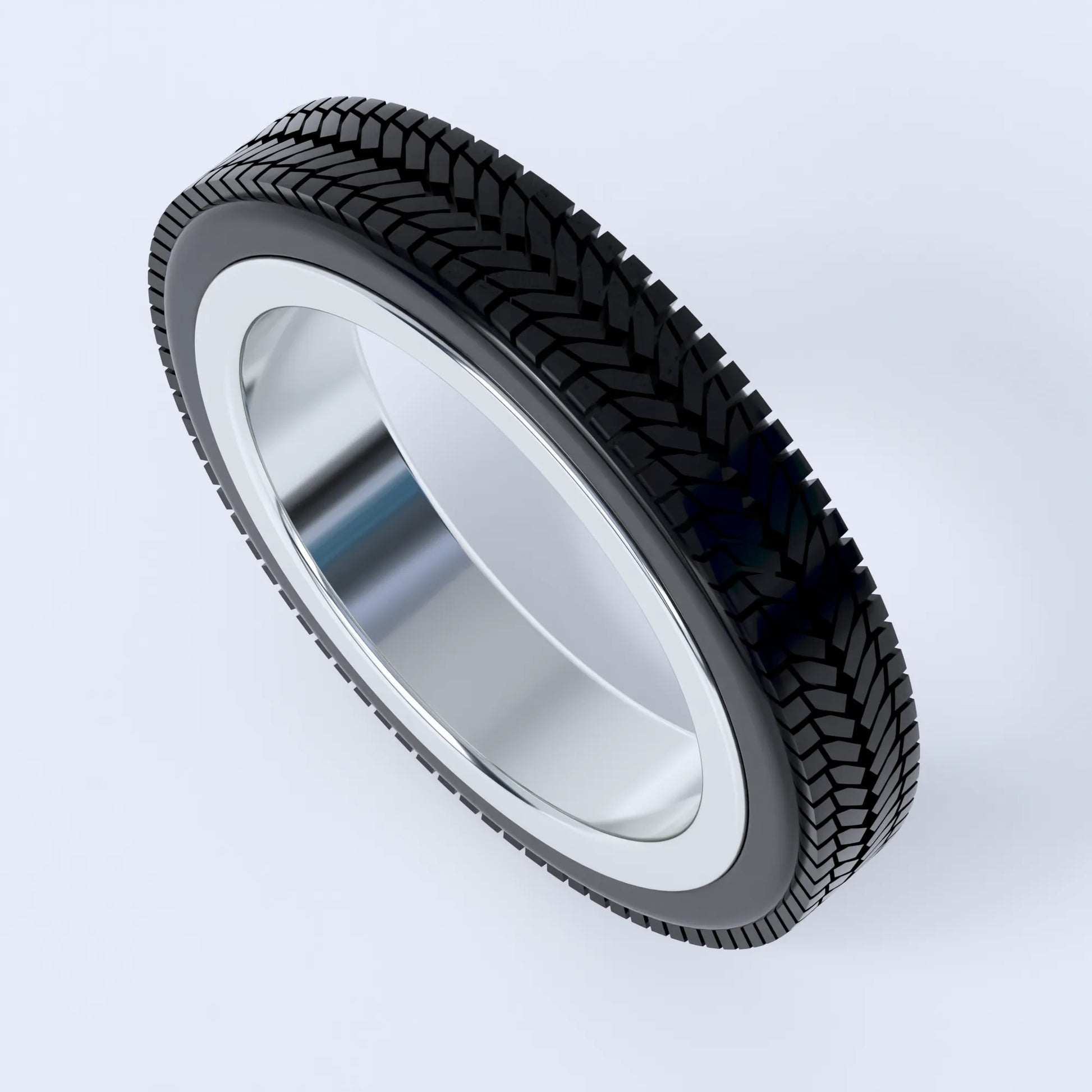Sterling silver ring on a white background, this ring is shaped like a car's tyre, and shows the design in silver with the 3d printed tyre